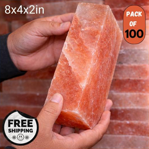 Himalayan salt block held by a hand with product details on an orange background