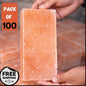 Himalayan salt block held by a hand with promotional text on an orange background